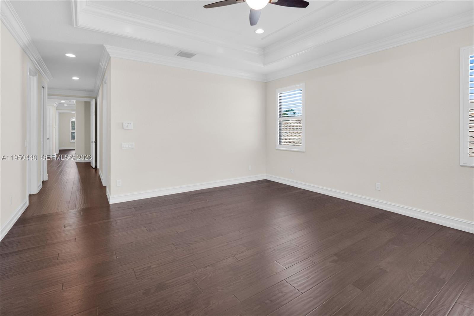 8944 Little Falls Way, Unit 8944 Delray Beach, FL 33446 - Photo 44 of 98 an empty room with wooden floor and windows