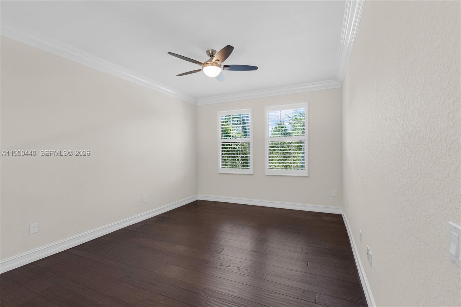 8944 Little Falls Way, Unit 8944 Delray Beach, FL 33446 - Photo 45 of 98 a view of an empty room with wooden floor and a window