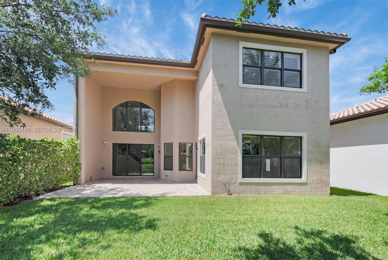 8944 Little Falls Way, Unit 8944 Delray Beach, FL 33446 - Photo 54 of 98 front view of a house with a small yard