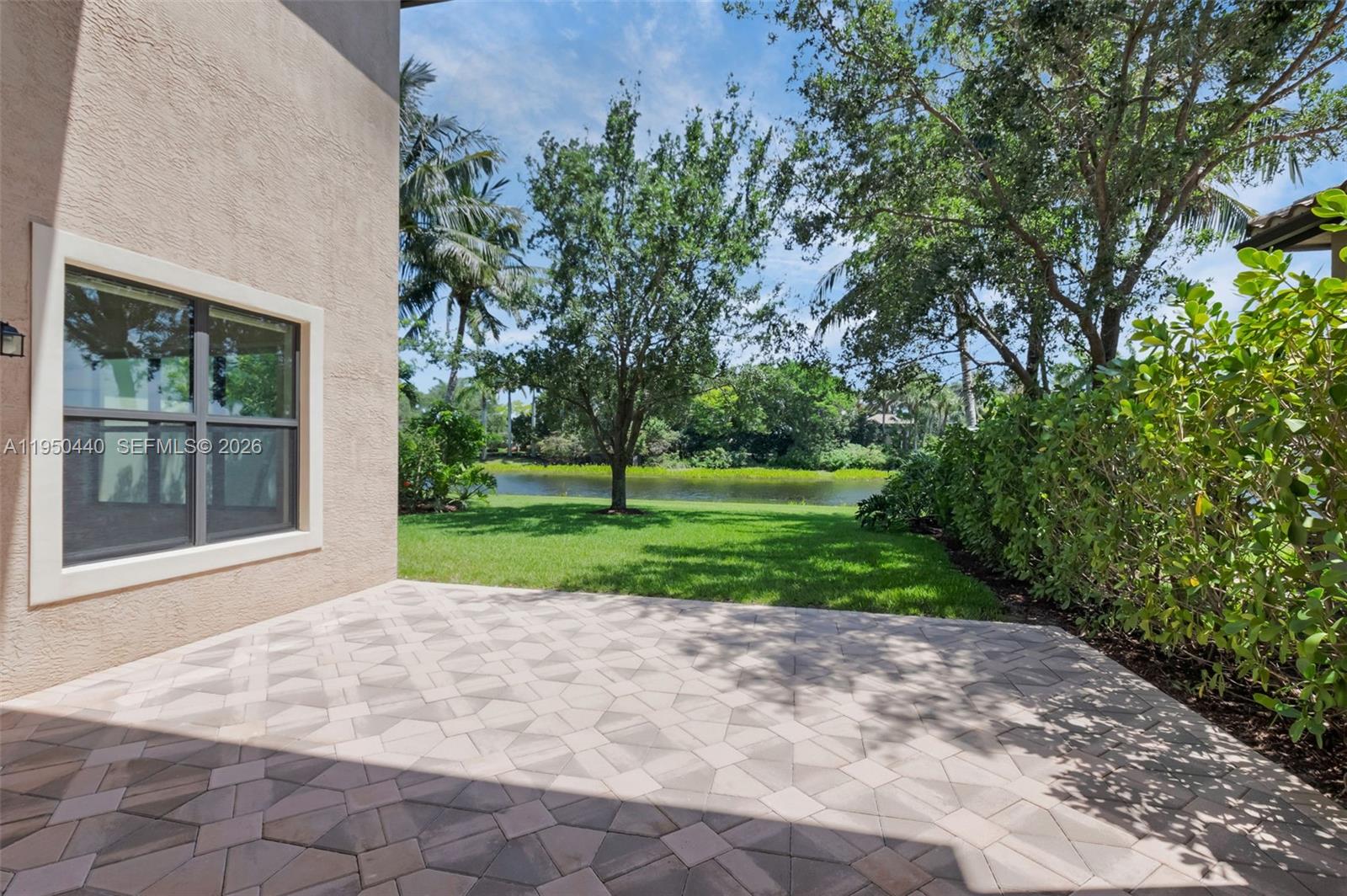8944 Little Falls Way, Unit 8944 Delray Beach, FL 33446 - Photo 55 of 98 a view of a house with a yard and large trees