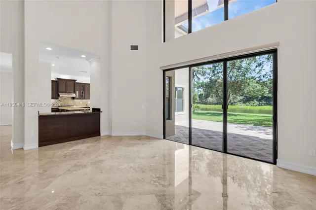 a large kitchen with granite countertop a sink and dishwasher with wooden floor