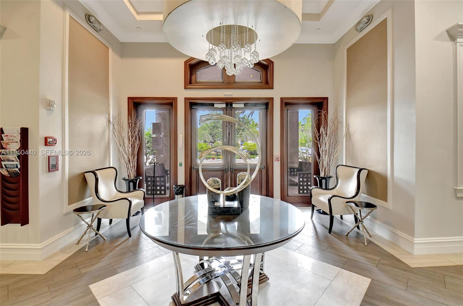 8944 Little Falls Way, Unit 8944 Delray Beach, FL 33446 - Photo 86 of 98 a view of a dining room with furniture a chandelier and large windows