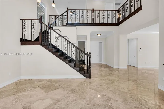 a view of an empty room with a window and fireplace