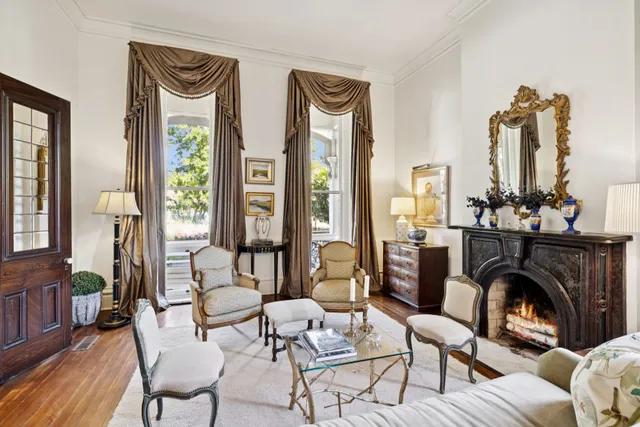 a dining room with furniture a chandelier and wooden floor