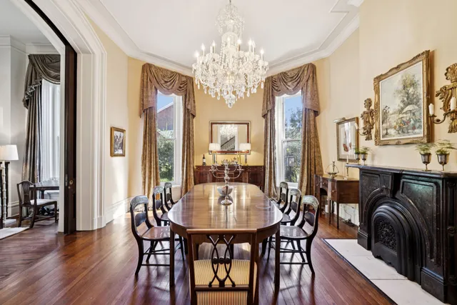 a living room with furniture and a dining table with wooden floor