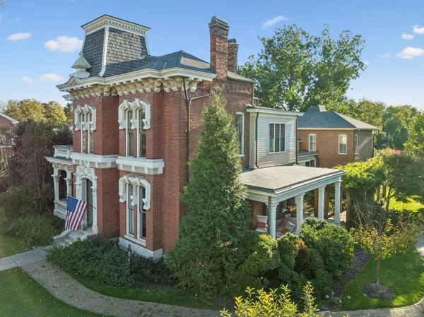 a view of a dining room with furniture a chandelier and wooden floor