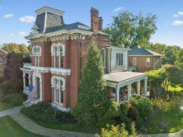 a view of a dining room with furniture a chandelier and wooden floor