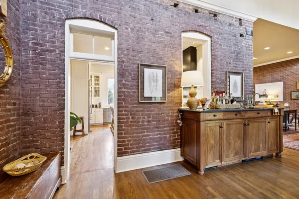 a living room with fireplace furniture and a chandelier
