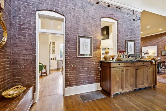 a living room with fireplace furniture and a chandelier