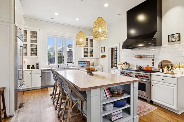 a spacious bathroom with a granite countertop sink a mirror and a shower
