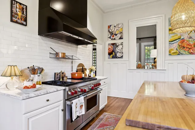 a kitchen with stainless steel appliances granite countertop a stove a sink and a refrigerator