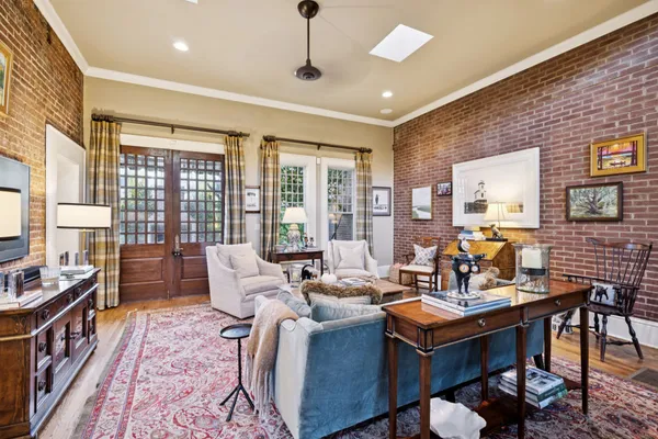 a living room with lots of furniture and a large window