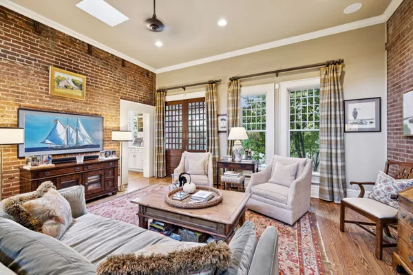 a view of a patio with table and chairs potted plants and a large tree