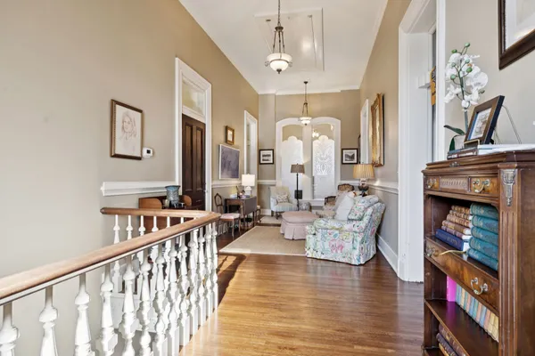 a view of a patio with table and chairs potted plants with wooden floor and fence