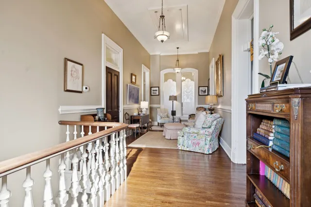 a view of a patio with table and chairs potted plants with wooden floor and fence