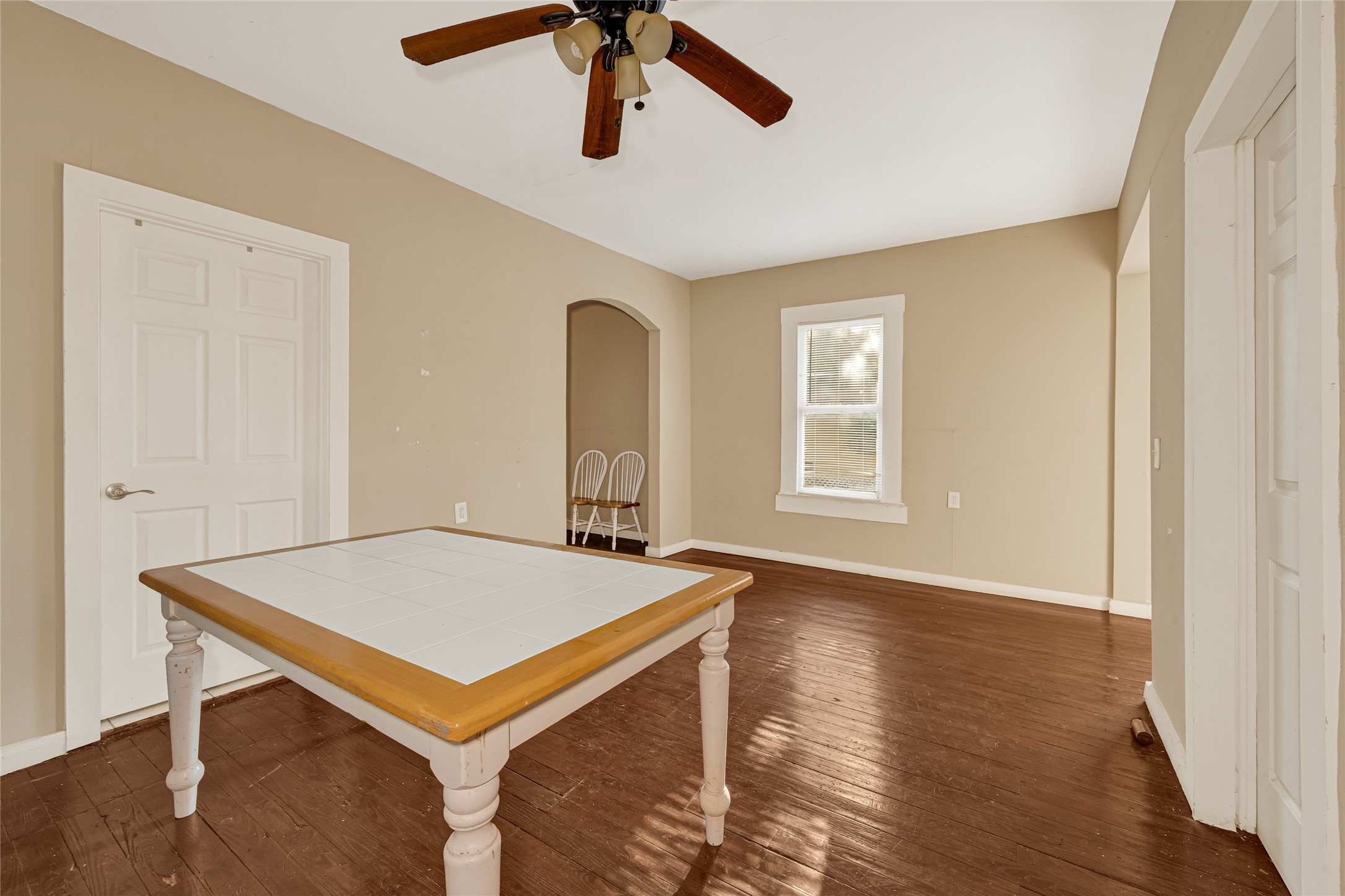 7305 Tremper Street Houston, TX 77020 - Photo 7 of 28 a view of an empty room with window and wooden floor