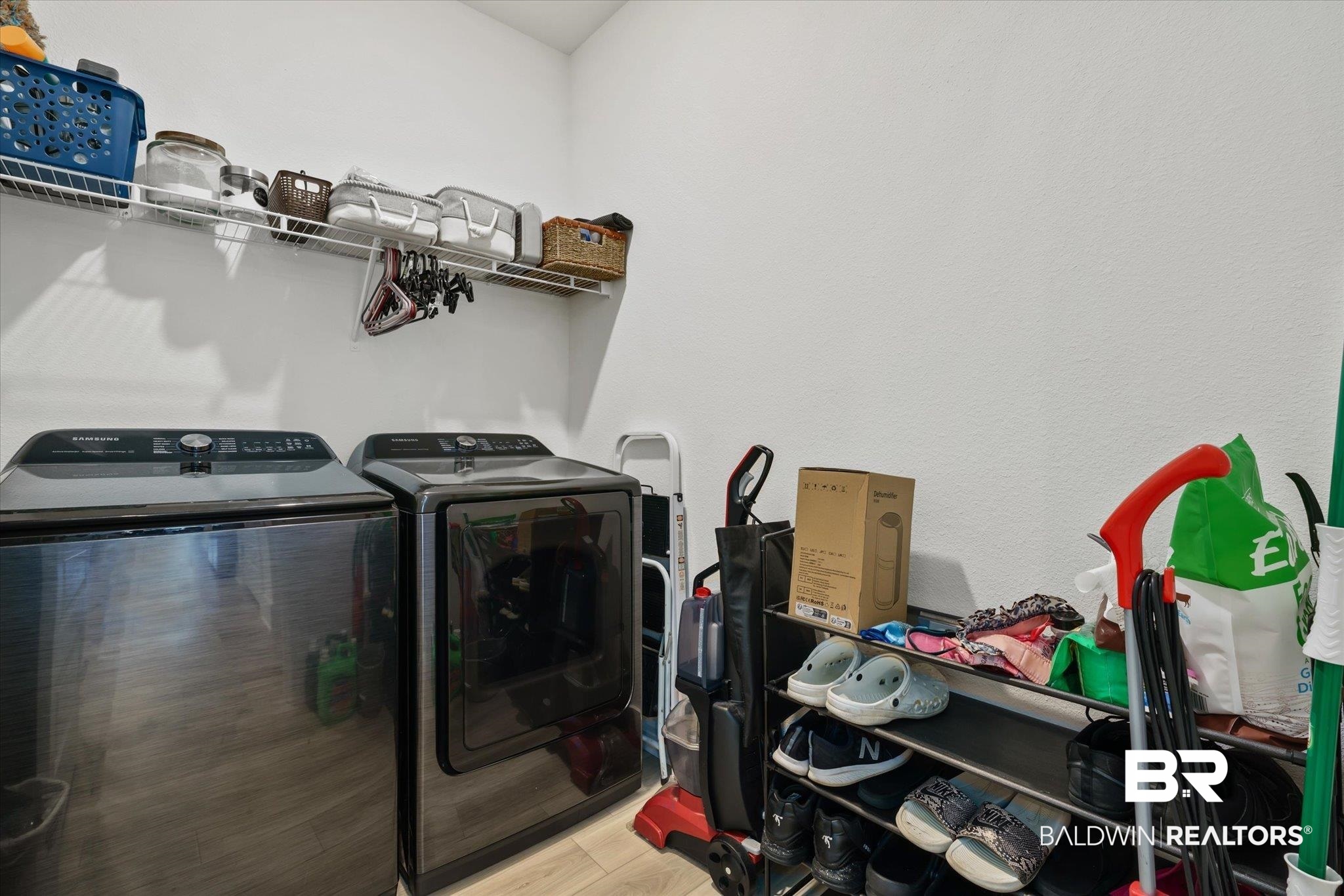 263 Bronze Street Fairhope, AL 36532 - Photo 28 of 47 Laundry area featuring light wood-type flooring and washing machine and dryer