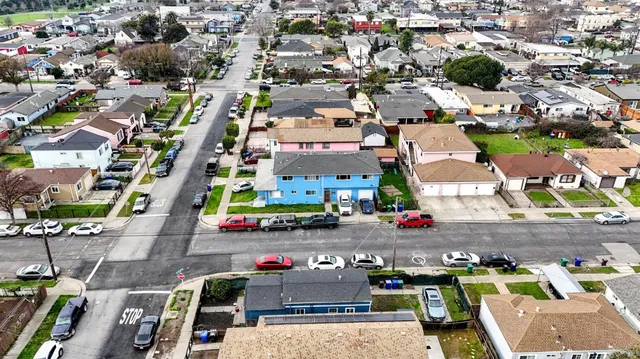 an aerial view of a house with a yard and potted plants