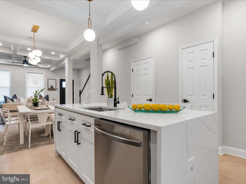 1645 Normal Avenue Baltimore, MD 21213 - Photo 16 of 53 a kitchen with kitchen island granite countertop a sink a stove and cabinets