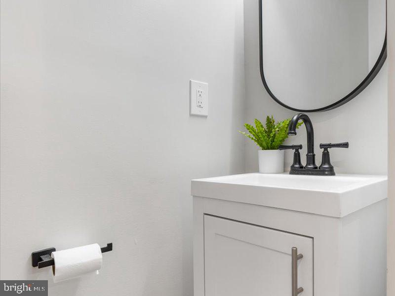 1645 Normal Avenue Baltimore, MD 21213 - Photo 18 of 53 a bathroom with a sink and a mirror