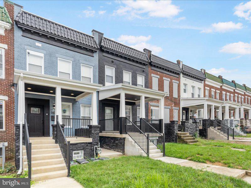 1645 Normal Avenue Baltimore, MD 21213 - Photo 2 of 53 a front view of a house with a yard table and chairs