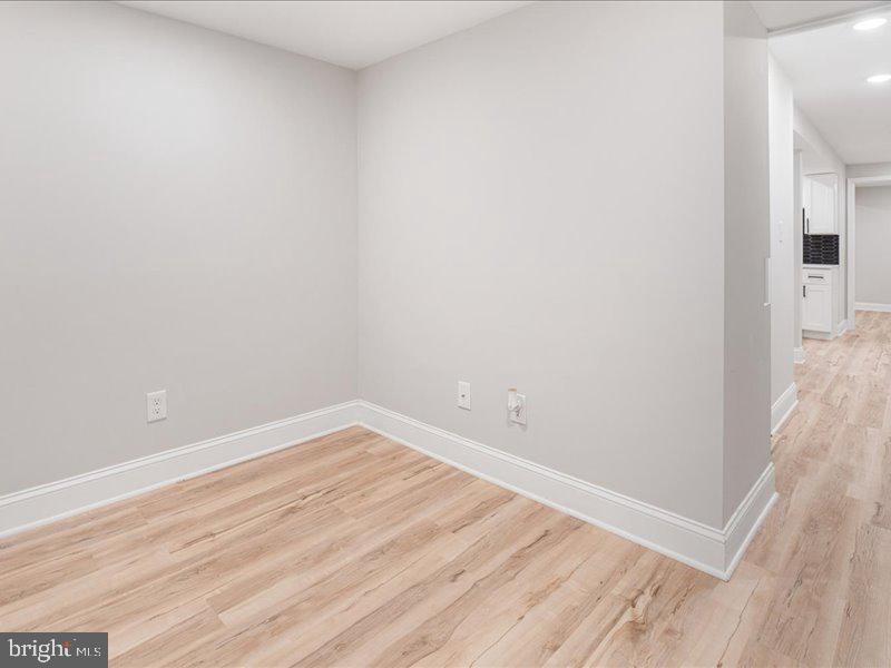 1645 Normal Avenue Baltimore, MD 21213 - Photo 25 of 53 an empty room with wooden floor
