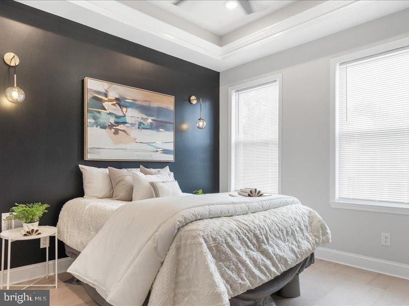 1645 Normal Avenue Baltimore, MD 21213 - Photo 28 of 53 a bedroom with a bed and a painting on the wall