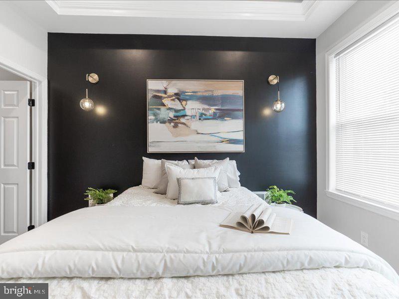 1645 Normal Avenue Baltimore, MD 21213 - Photo 29 of 53 a bedroom with a bed and painting on the wall