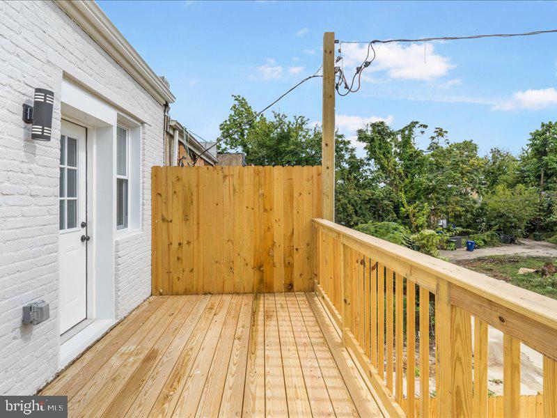 1645 Normal Avenue Baltimore, MD 21213 - Photo 48 of 53 a view of a balcony with wooden floor and fence