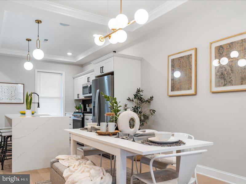 1645 Normal Avenue Baltimore, MD 21213 - Photo 9 of 53 a view of a dining room with furniture and chandelier