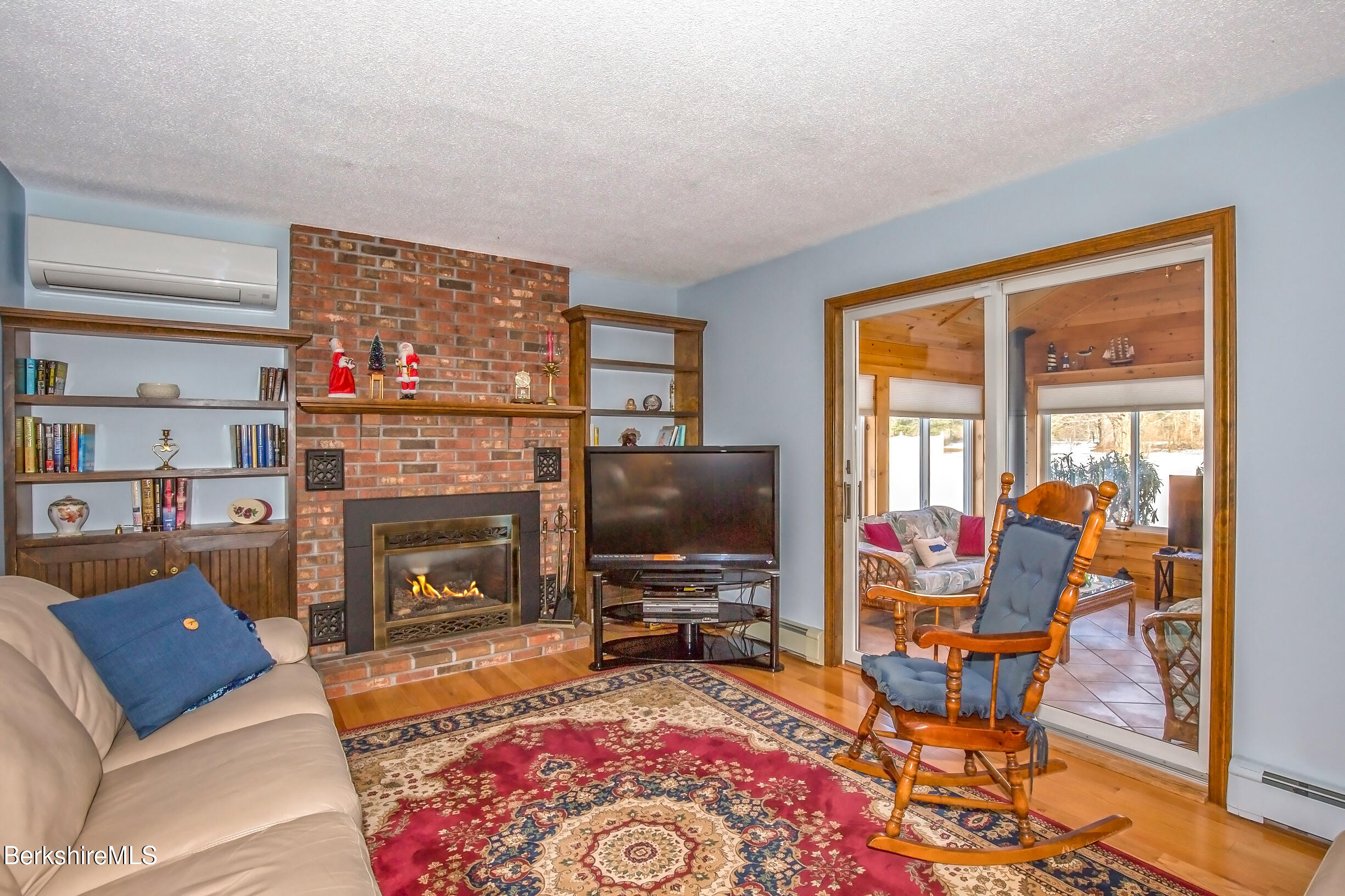 71 King William Road Lenox, MA 01240 - Photo 2 of 43 a living room with furniture a flat screen tv and a fireplace