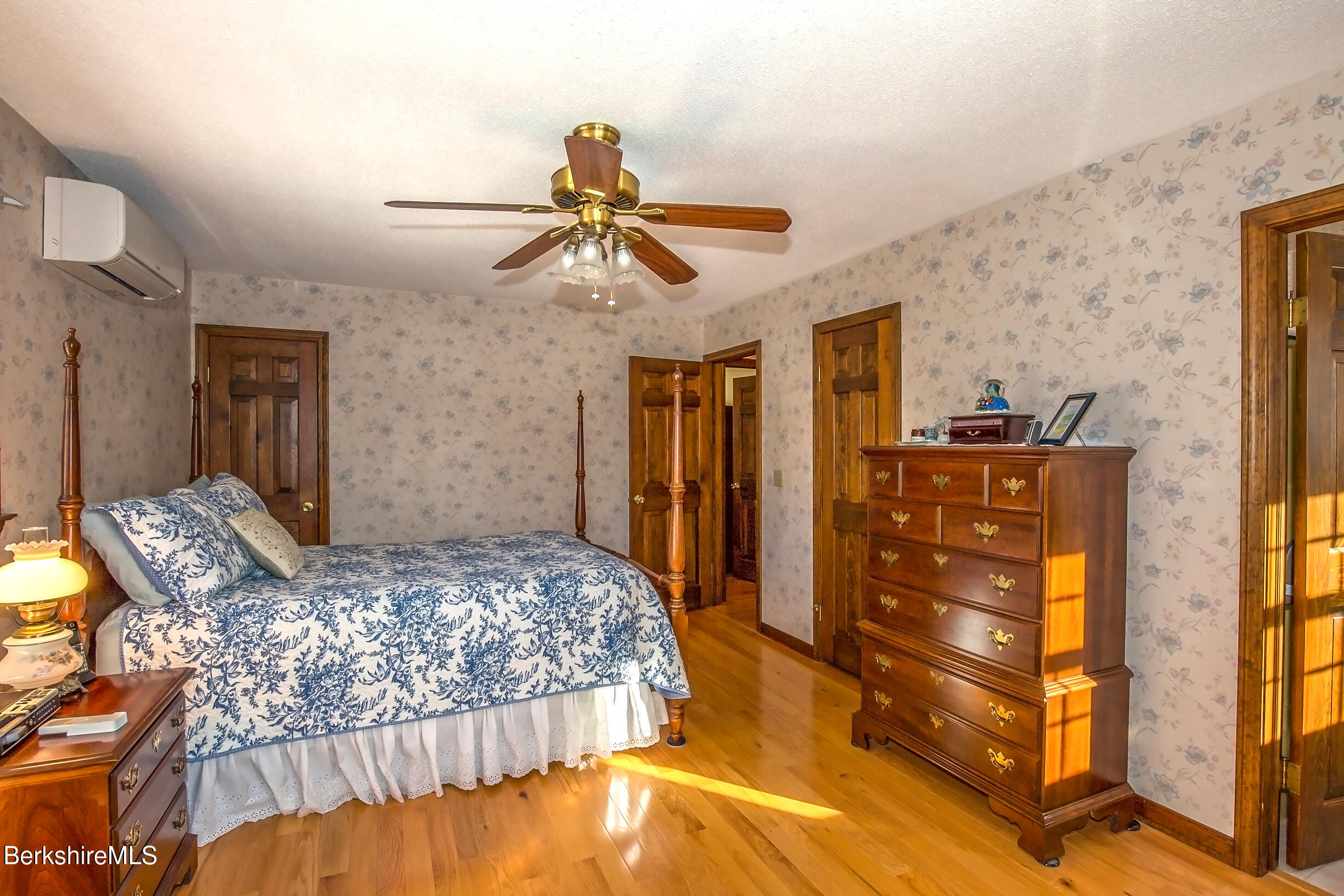 71 King William Road Lenox, MA 01240 - Photo 21 of 43 a bedroom with a bed and a chandelier