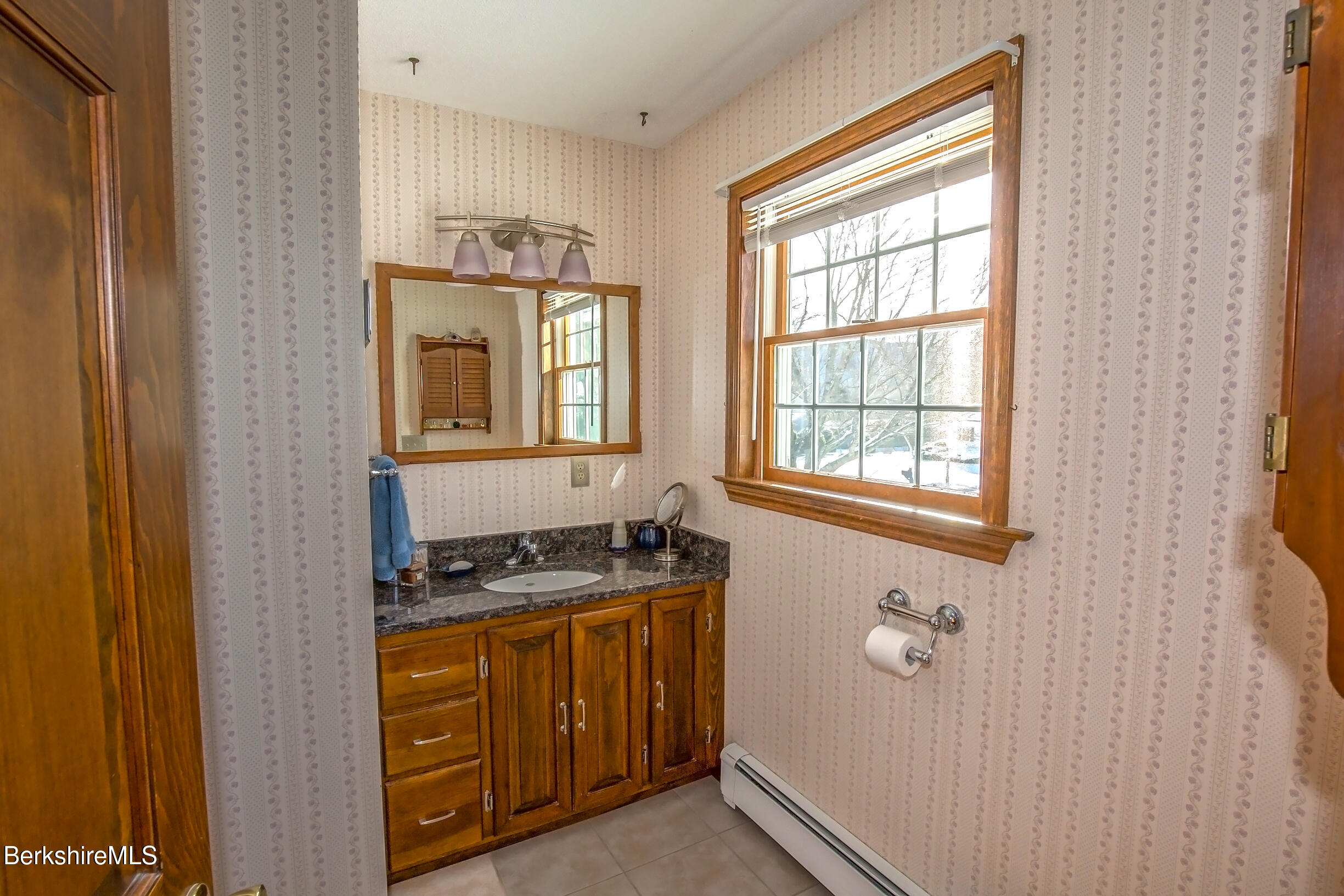 71 King William Road Lenox, MA 01240 - Photo 22 of 43 a bathroom with a granite countertop sink and a window