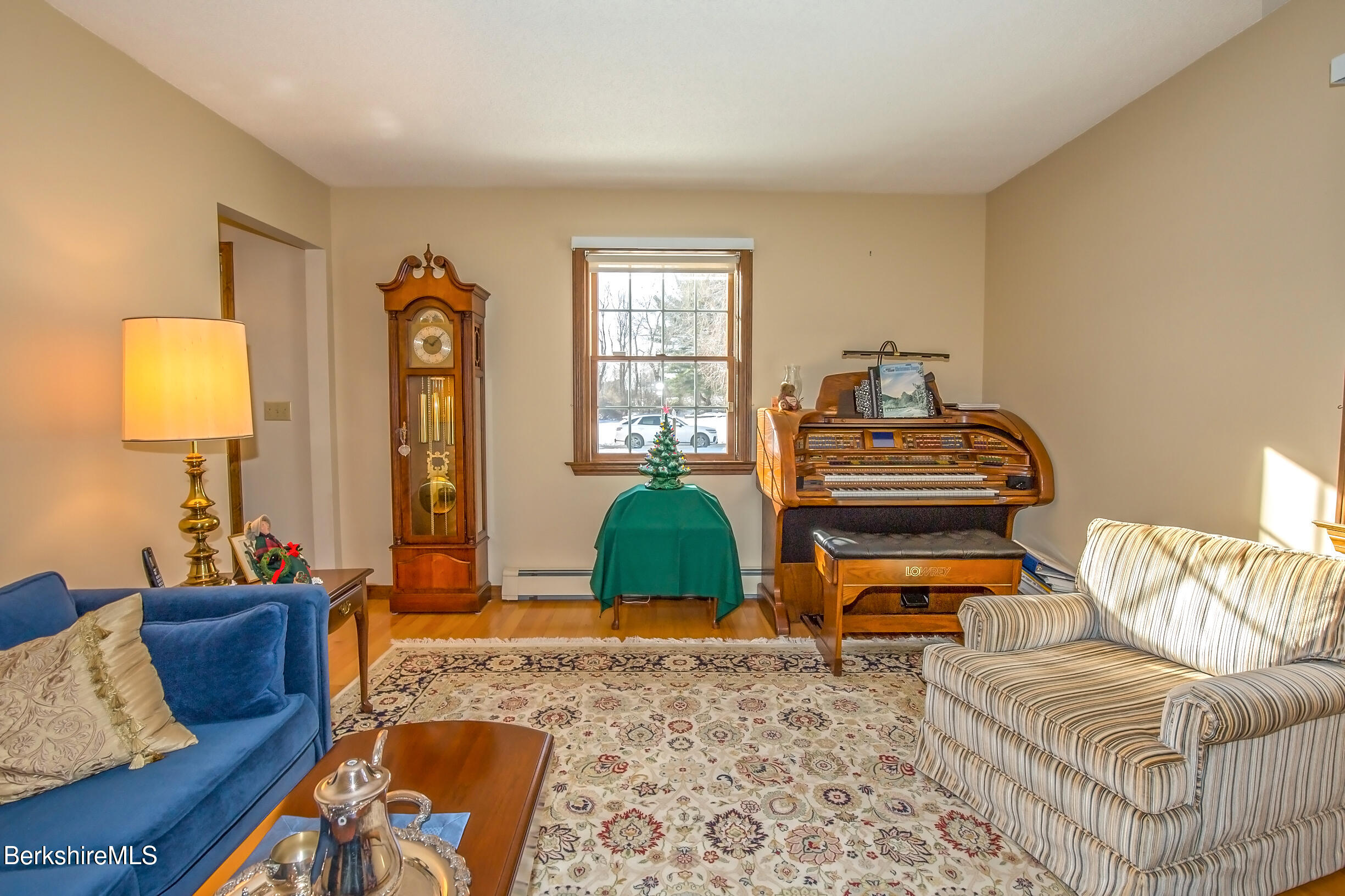 71 King William Road Lenox, MA 01240 - Photo 8 of 43 a living room with furniture a rug and a lamp