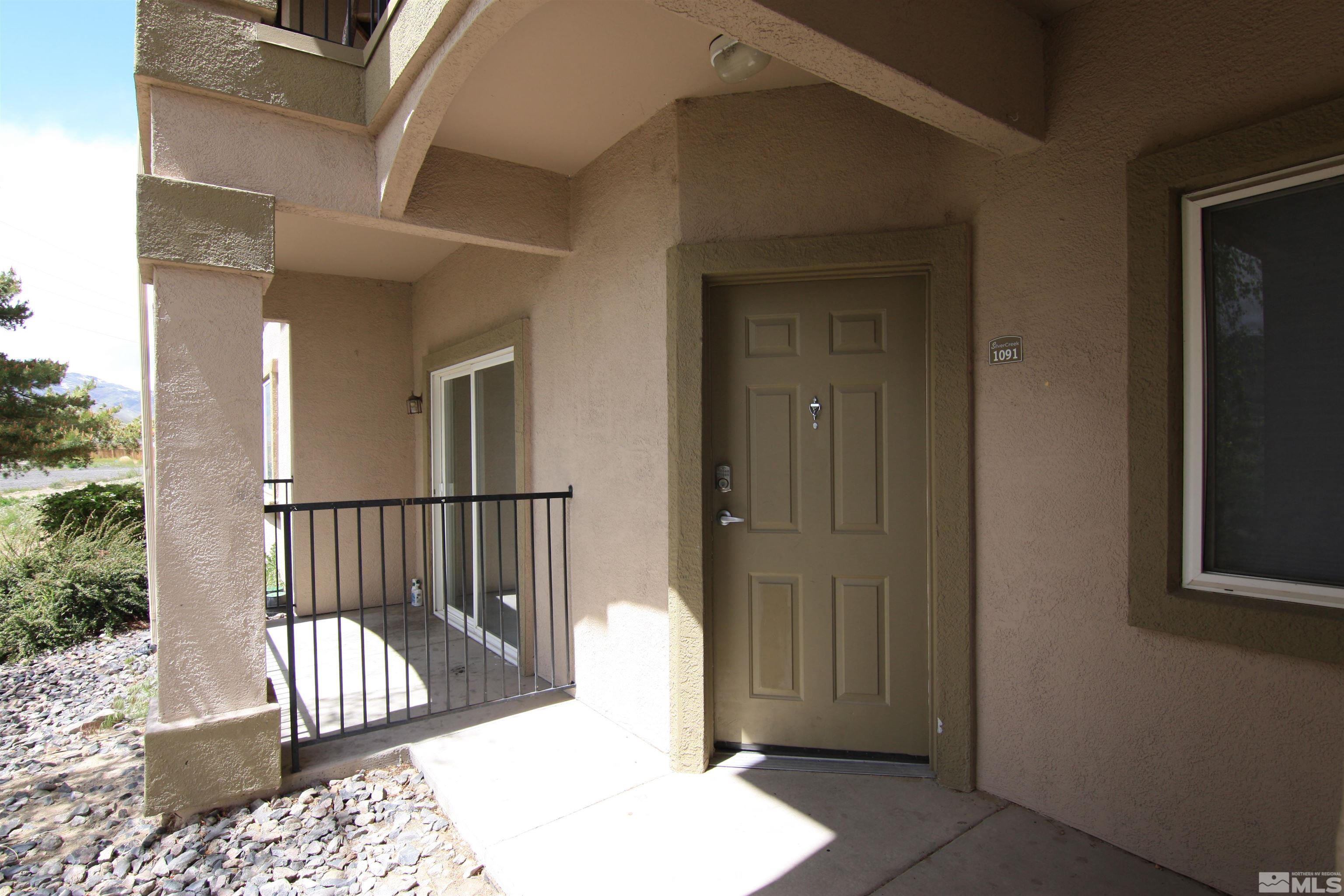 6850 Sharlands Avenue, Unit 1091 Reno, NV 89523 - Photo 2 of 11 a view of a porch with a table and chairs
