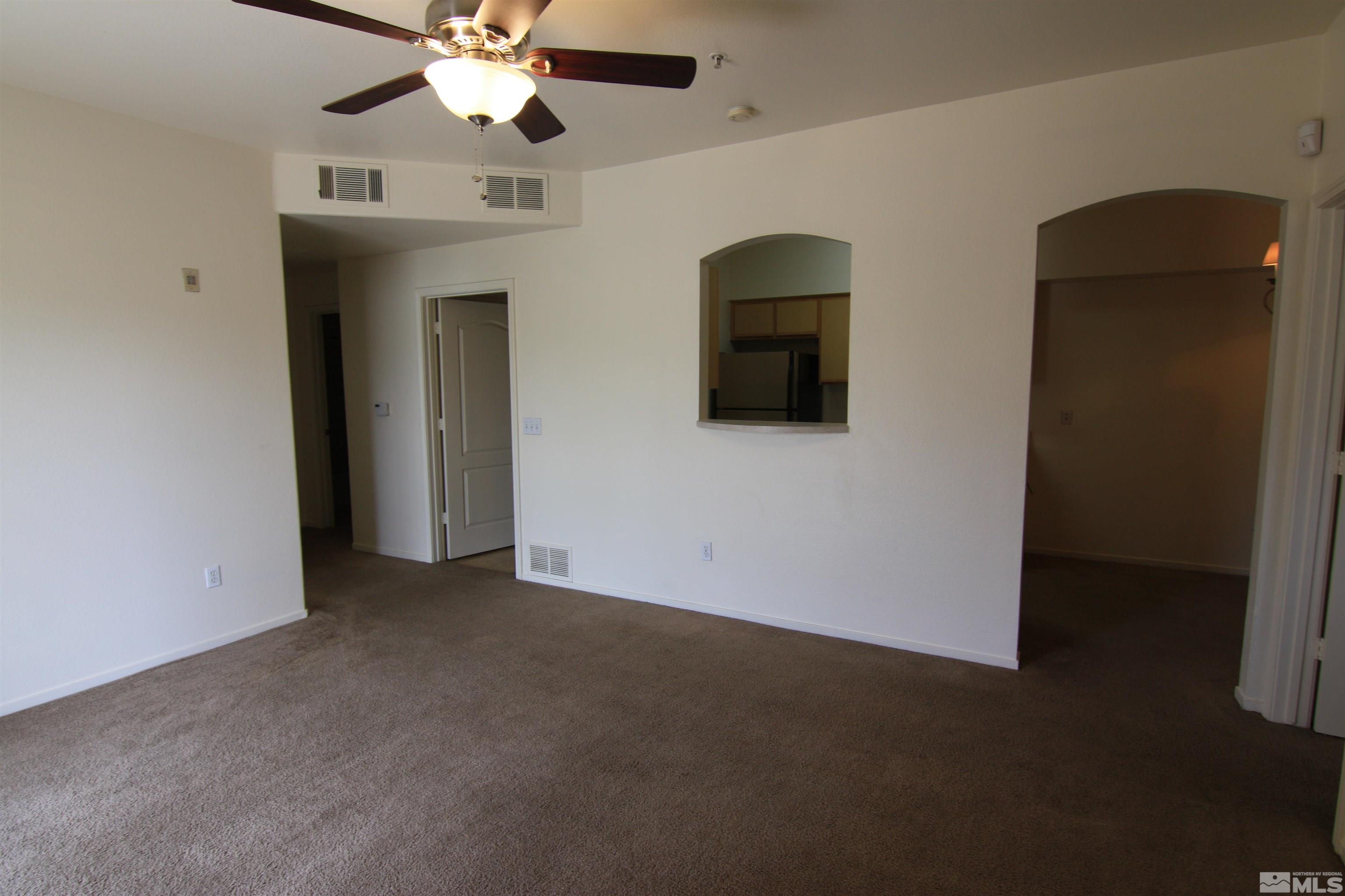 6850 Sharlands Avenue, Unit 1091 Reno, NV 89523 - Photo 4 of 11 a view of an empty room with a chandelier fan