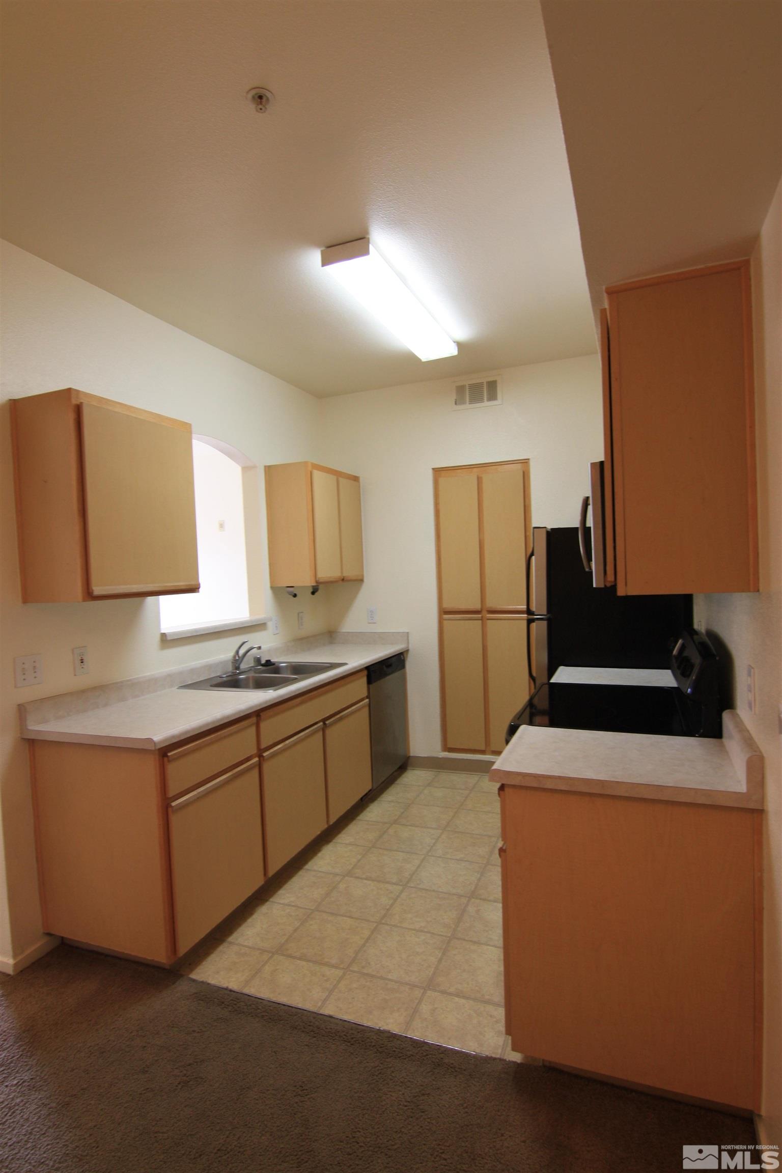 6850 Sharlands Avenue, Unit 1091 Reno, NV 89523 - Photo 5 of 11 a kitchen with stainless steel appliances granite countertop a sink and a refrigerator