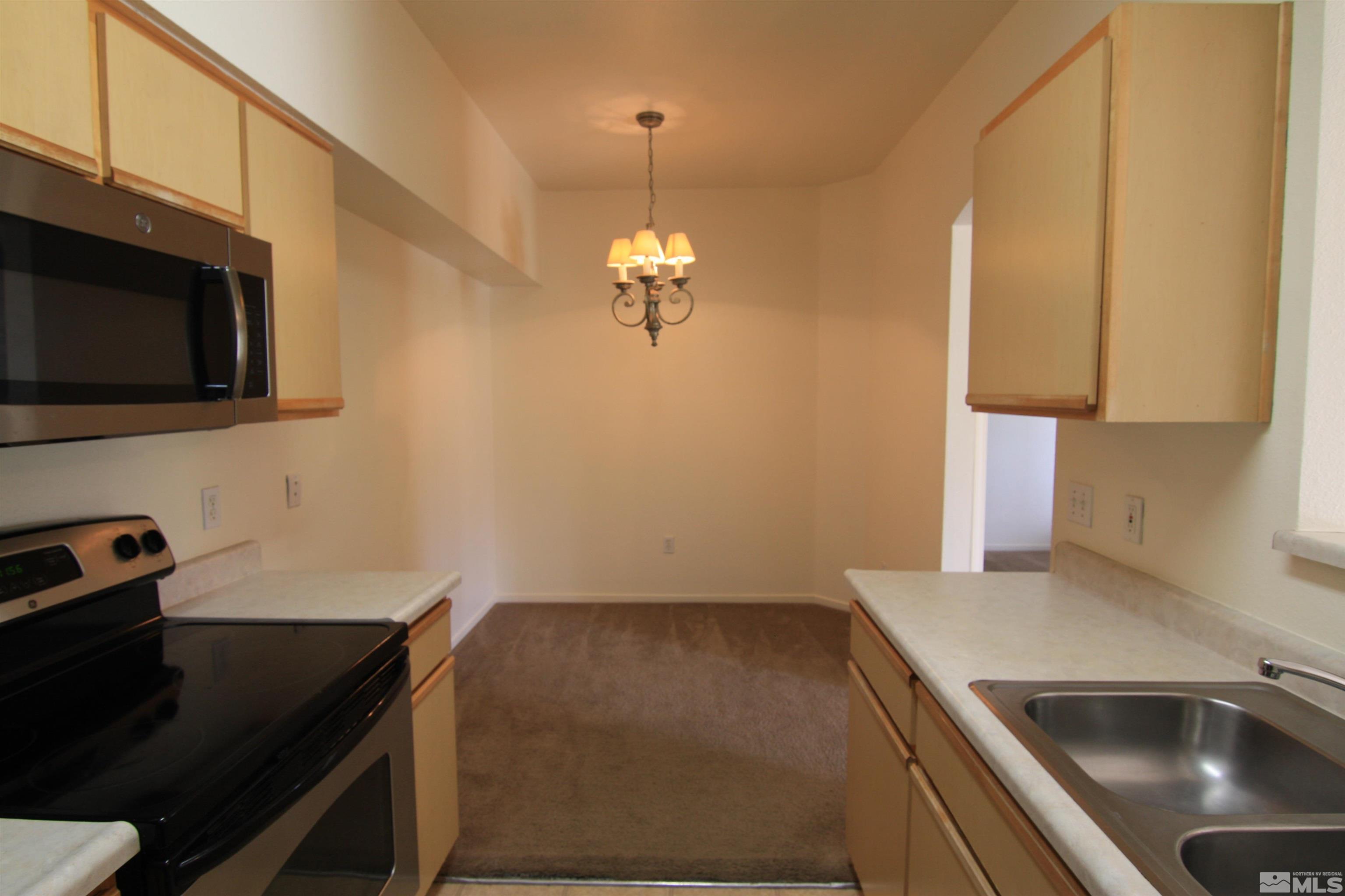 6850 Sharlands Avenue, Unit 1091 Reno, NV 89523 - Photo 6 of 11 a kitchen with a sink and cabinets