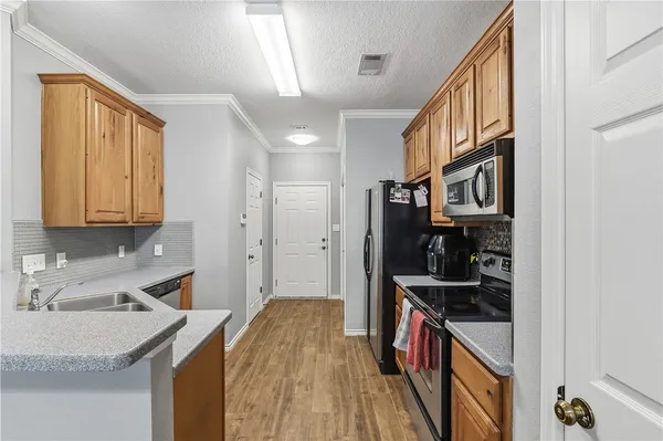 a kitchen with stainless steel appliances granite countertop a sink and cabinets