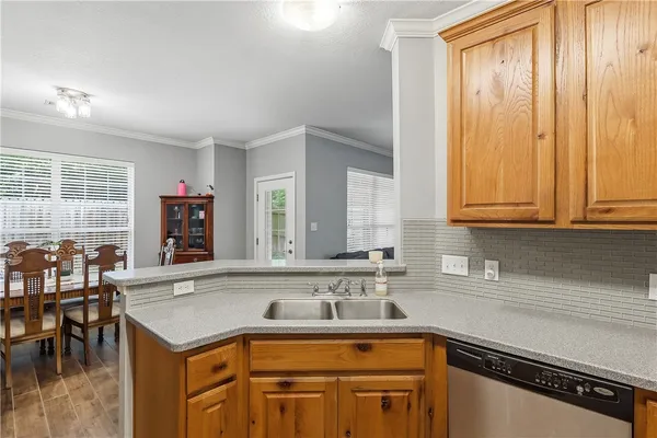a kitchen with a sink cabinets and outdoor space