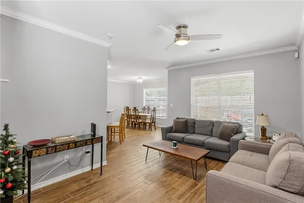 a living room with furniture and wooden floor