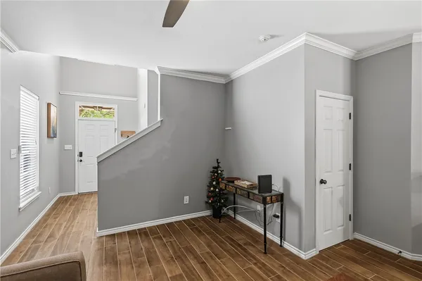 a view of a hallway with wooden floor and staircase