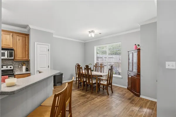 a view of a dining room with furniture and a window