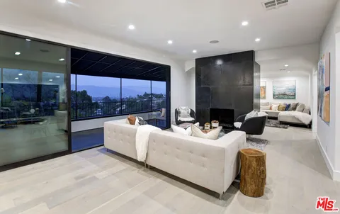 a living room with furniture and large windows