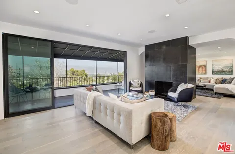 a view of sitting area with furniture and floor to ceiling window