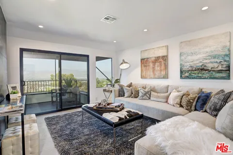 a view of a livingroom with furniture and a window