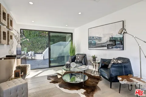 a kitchen with stainless steel appliances a table and chairs in it