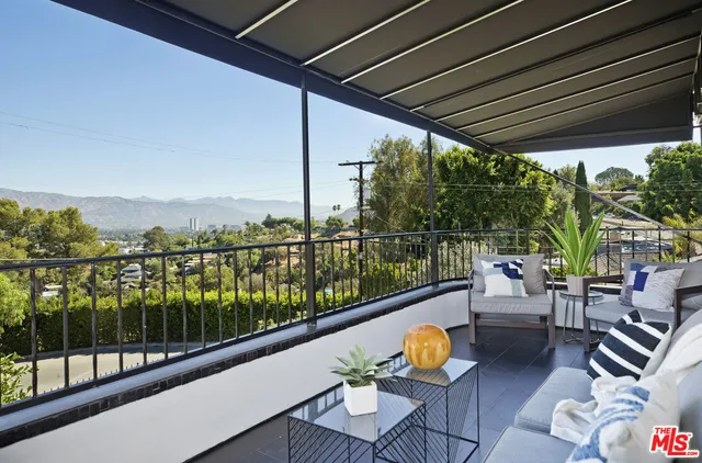 a view of a chairs and table in patio with a potted plant