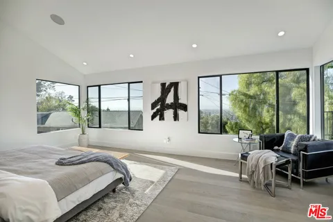 a bed sitting in a bedroom next to a window