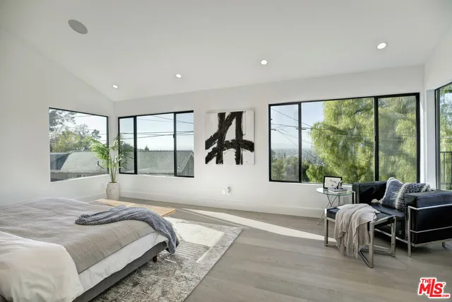 a bed sitting in a bedroom next to a window